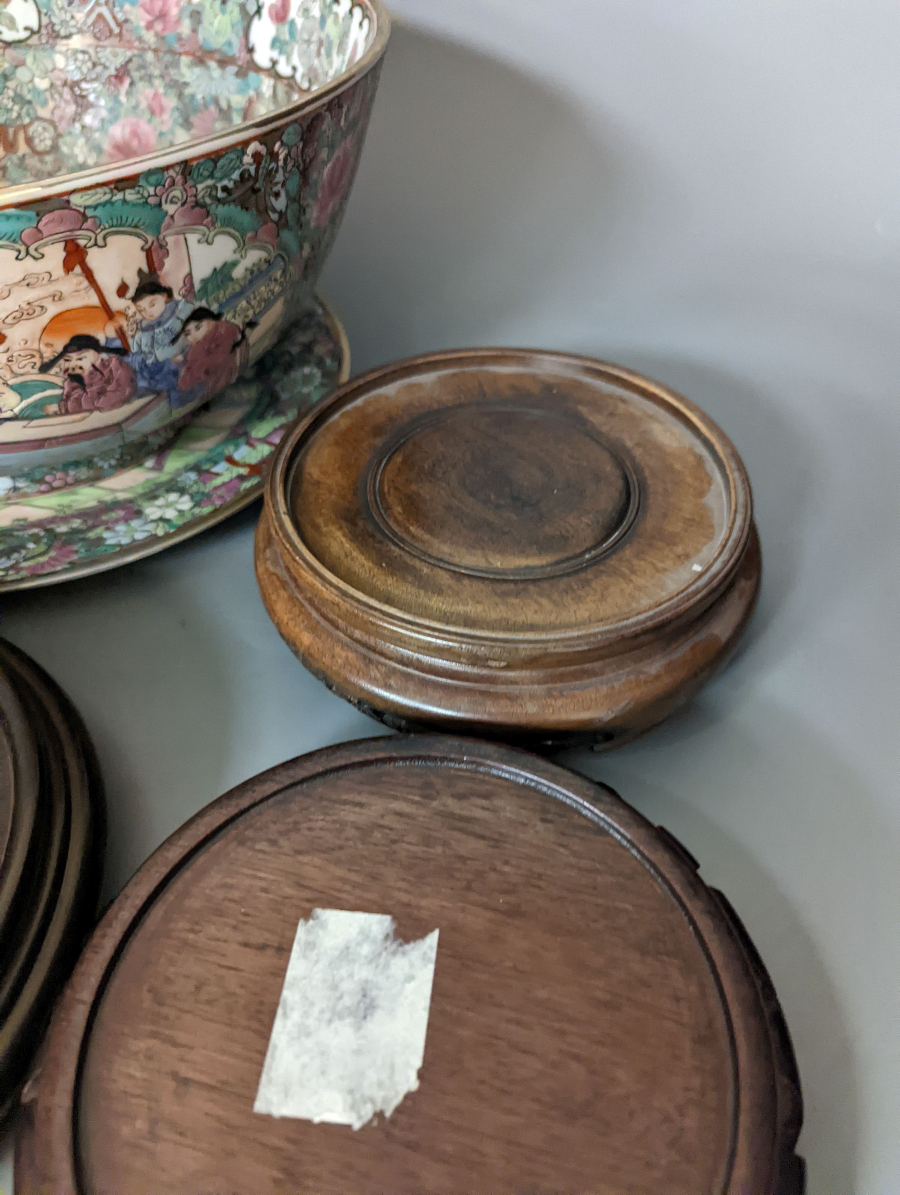 A Chinese famille rose bowl, plate and four stands, bowl 31 cms diameter.